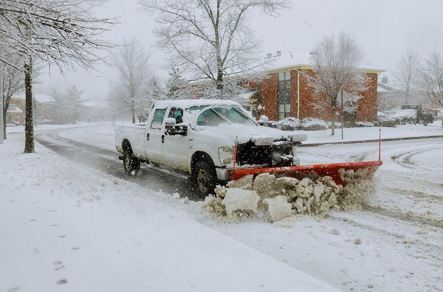 Snow Plow Removing Snow From Street
